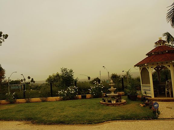 Gorgeous backyard with glass wall and city view on hazy day