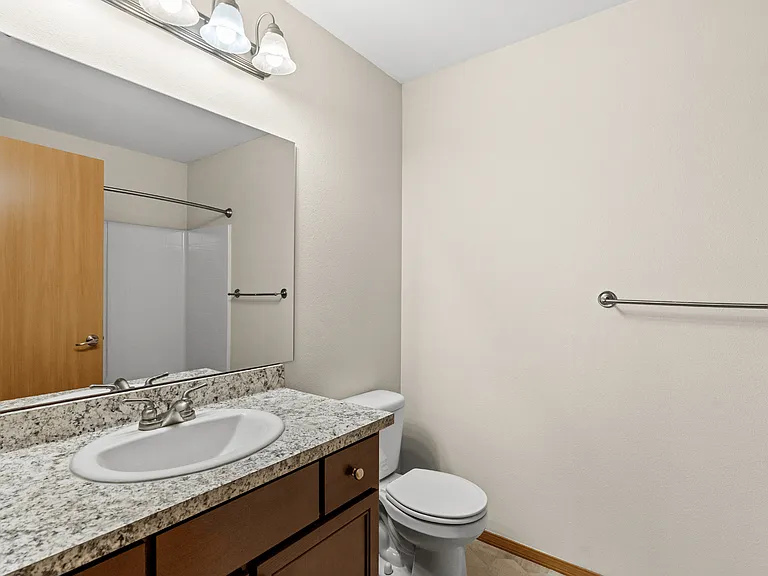Bathroom with granite-style countertops, modern fixtures, and full-size tub/shower Bathroom with granite-style countertops, modern fixtures, and full-size tub/shower