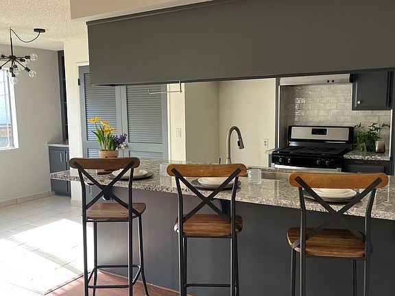 Laundry hook up behind double doors, with lots of extra storage.