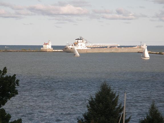 Watch the large freighter navigate the mouth of the Grand Ri