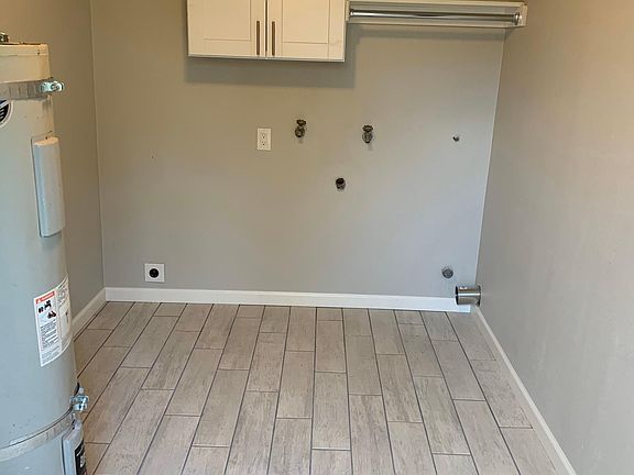 Heated and insulated Laundry room, off Garage and opens to fenced backyard.