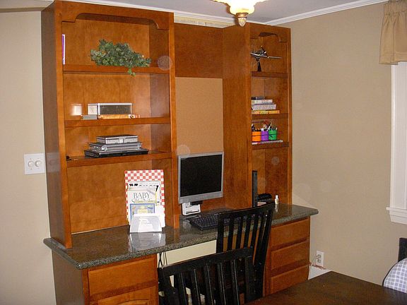 The built in kitchen desk has a granite countertop and access space for cmp. 