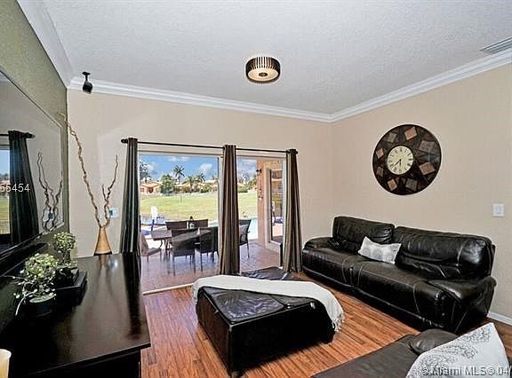 ENJOY COOKING IN THE OPEN KITCHEN WHILE EVERYONE IS WATCHING TV IN THE DEN!  LOTS OF LIGHT IN THE DEN FROM THE POOL AREA TOO!