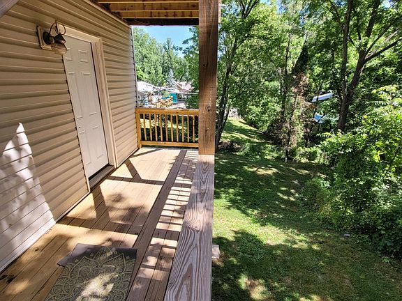 back deck with stair access to shared back yard and shared laundry area in basement
