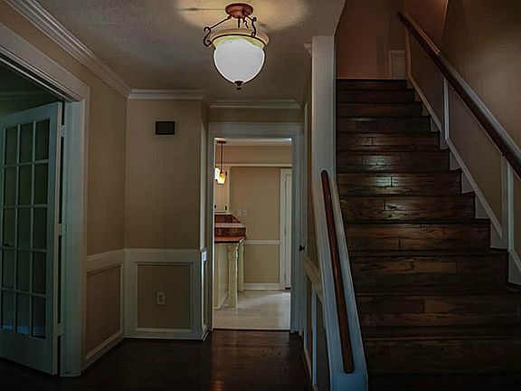 Gorgeous wood staircase greets you as you enter the front door.