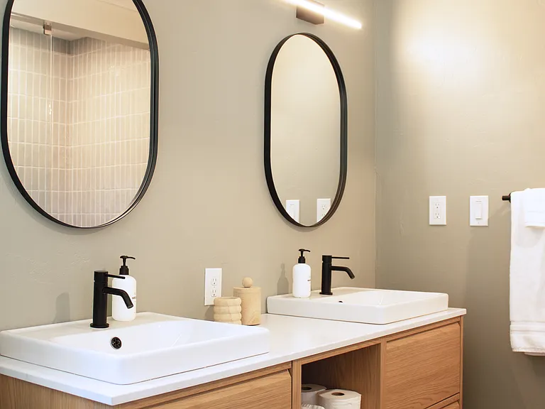 Double vanity bathroom with modern fixtures and ample storage in the primary bathroom.