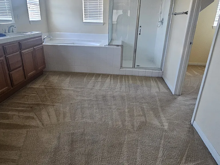 Master bathroom with tub and walk-in closet