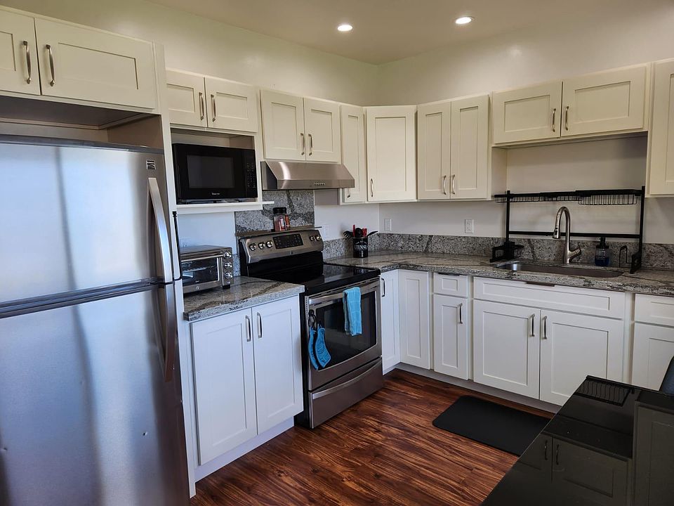 Large full kitchen with quartz countertops.