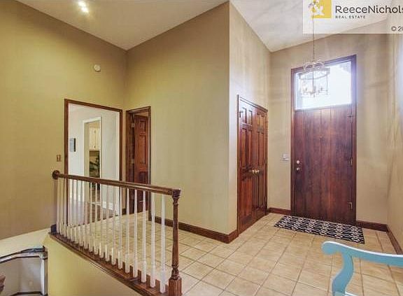 Spacious tiled foyer entry with coat/storage closet.