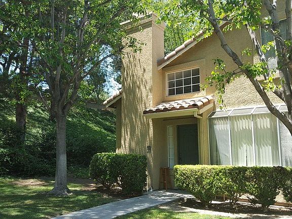 Front door. The property is adjacent to the serene green belt.