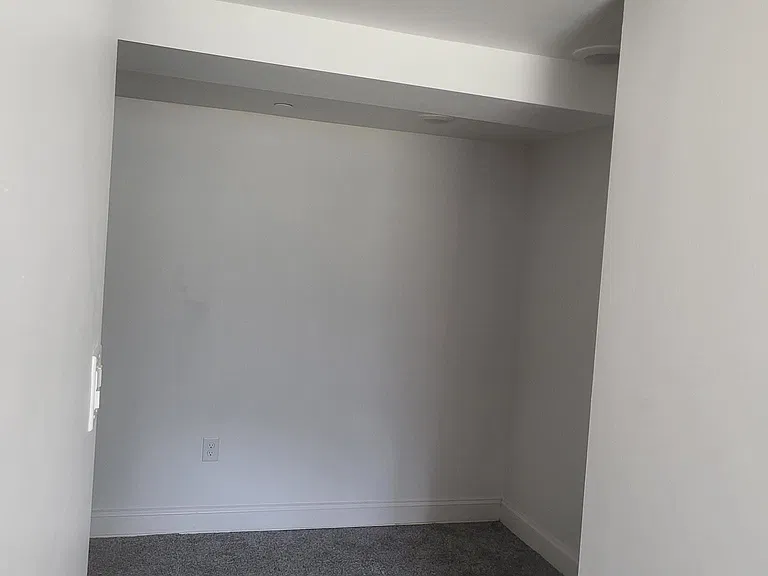 standing in hallway looking into bedroom