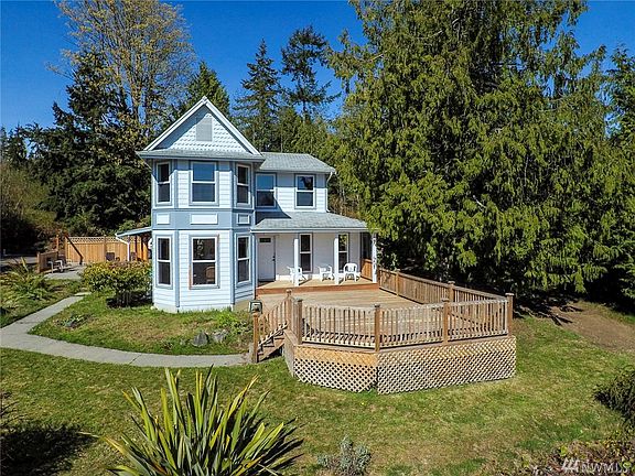 Victorian look but made for modern living. Deck and patio look over the grounds toward the water and mountain views.