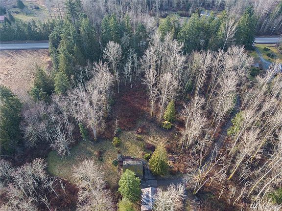Great drone shot showing the distance off the road and the treed privacy. 