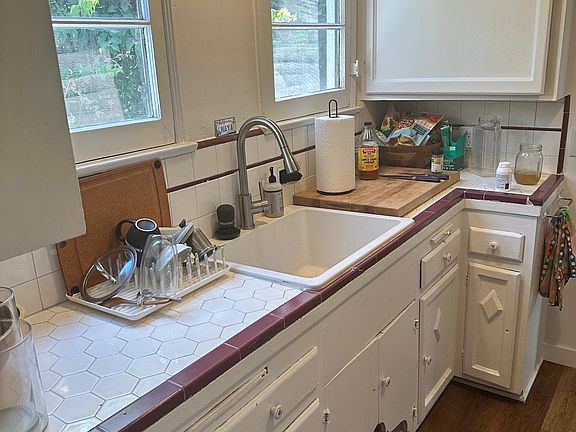 Sunny kitchen with classic design - new flooring and freshly painted walls and cabinets