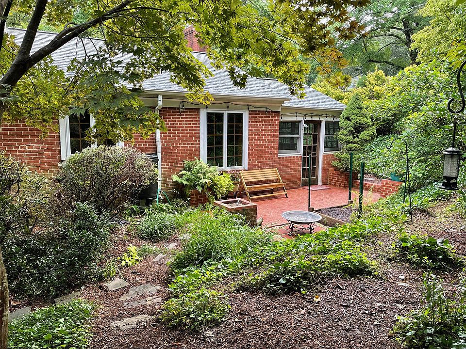 Enjoy the sounds of nature from the large, wooded back yard. Paths wind through the plantings to a brick patio.