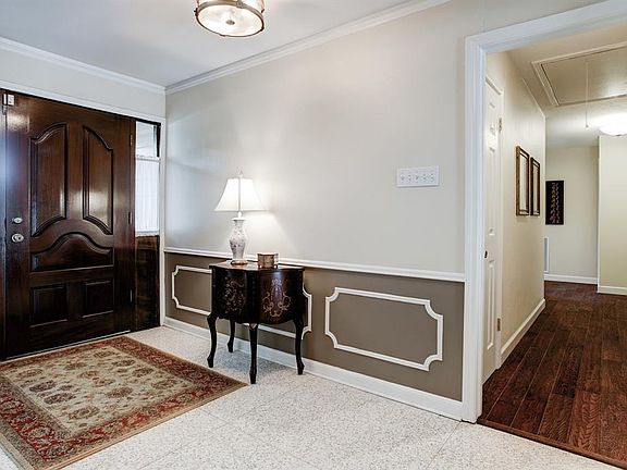 Entry/Foyer. 13'x5'6 Solid wood door with 3'6x9"side lites; diamond-honed cast Terrazzo floor in 2'6x3'3 sections, abutted; neut