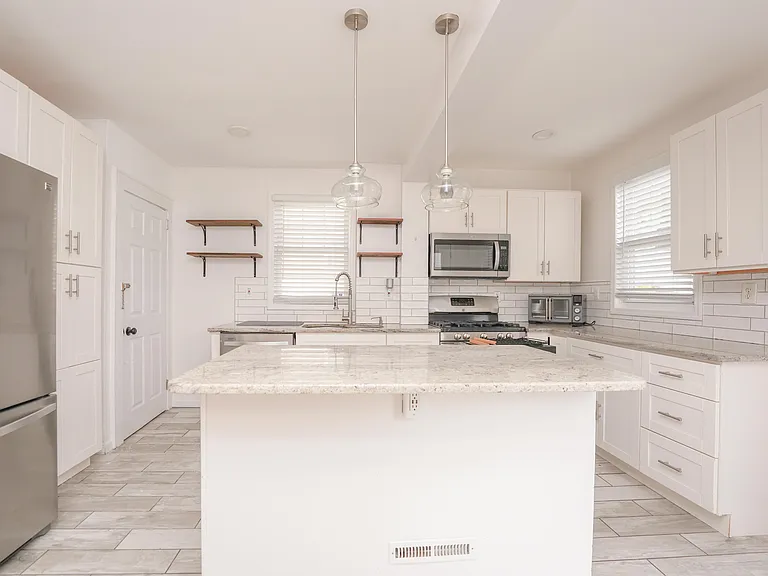 Spacious Kitchen
Leads down to basement and outdoor patio