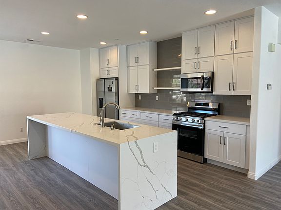 Newer redone kitchen with quartz countertops, stainless steel appliances and wine refrigerator included.