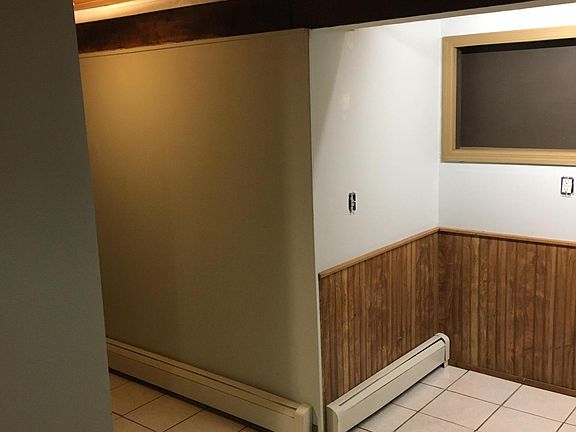 Corner of kitchen opposite countertop area. (a small table works well ithe space) *Note the HOT Water (boiler) baseboard heat*