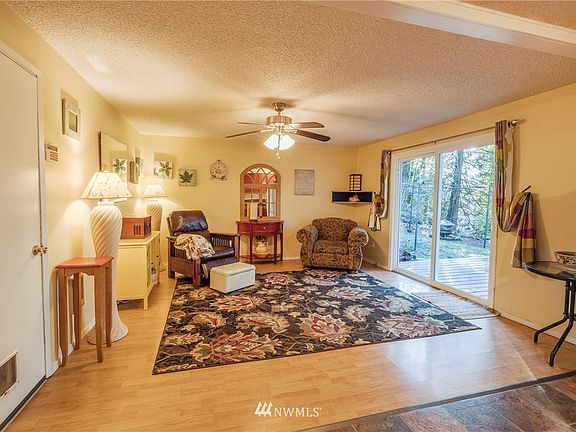 Another view of the living with laminate floors. The door to the left leads to your garage and laundry area. THe sliders lead your large 16 X 16 deck.
