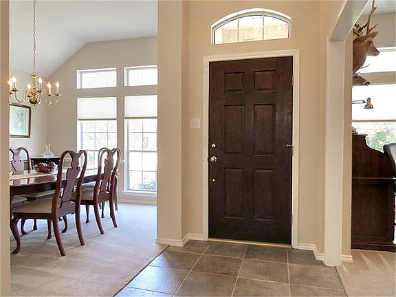 Wide, tiled foyer with faux transom window.
