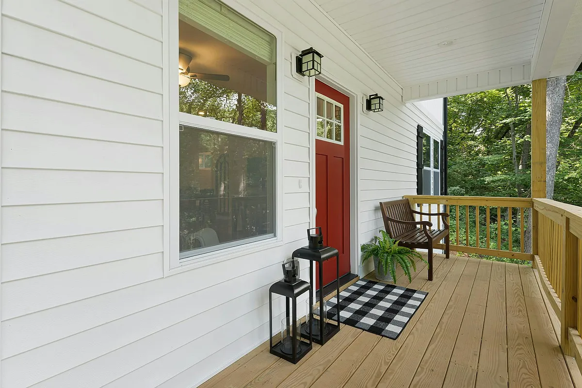 Inviting front porch elevated above main road - 461 Governors View Rd