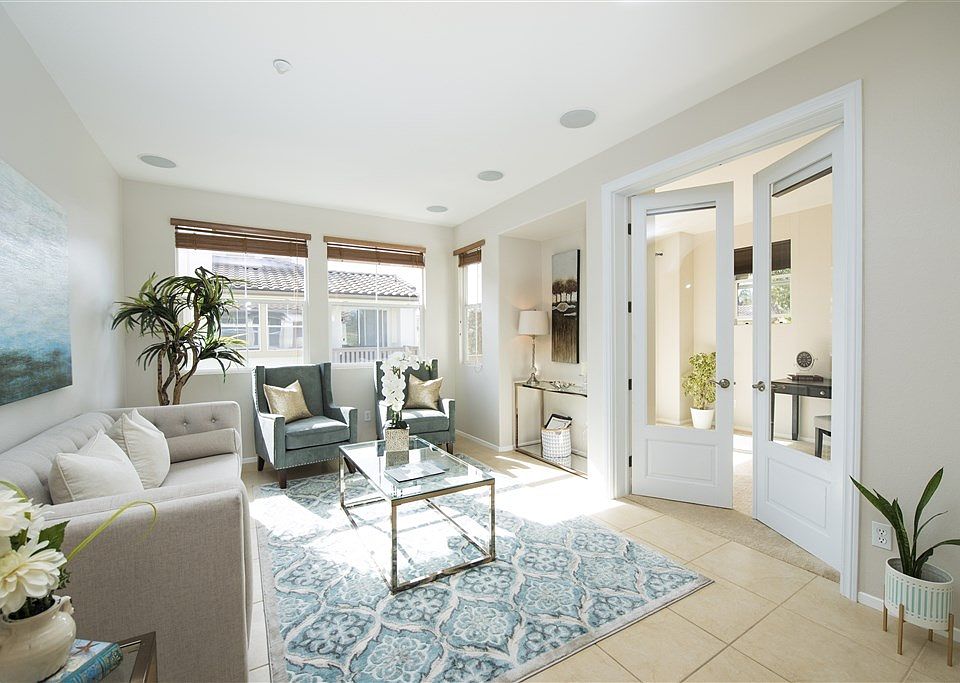 The living space has natural light and opens to the optional third bedroom or office/den.