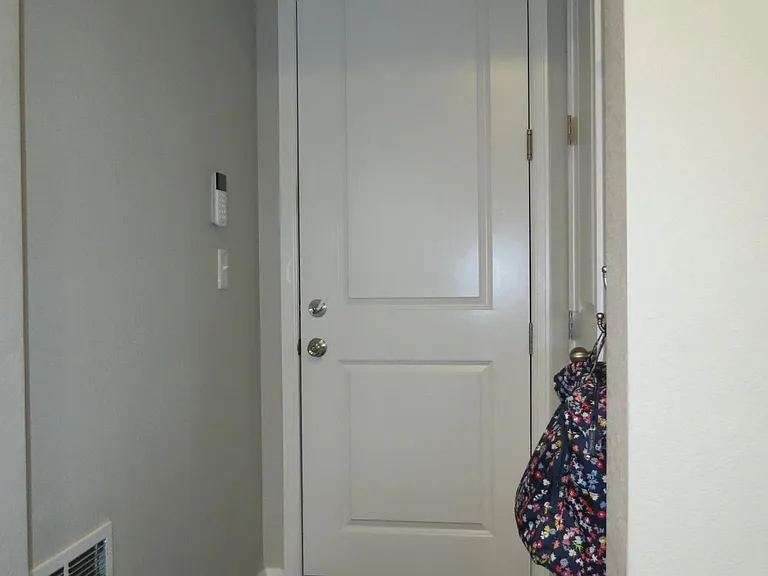 Doorway to garage with coat closet