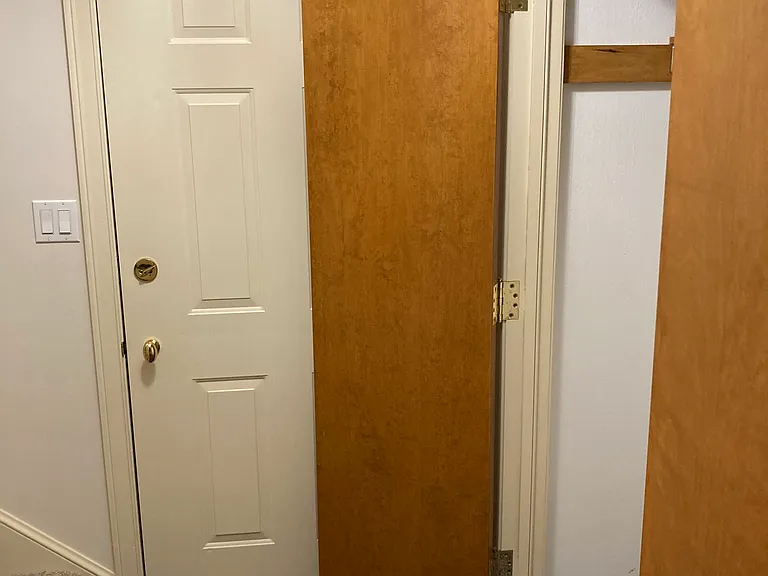 Coat Closet at entry from Garage and stairs to Living Level