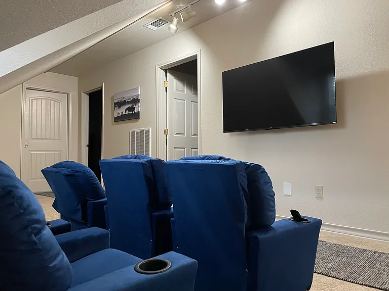 Upstairs area with children's recliner chairs (for little children only) and a TV.