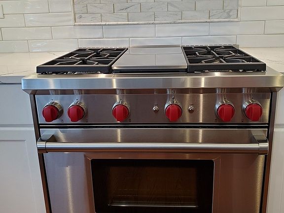 36" Wolfe Dual fuel range, custom designer marble backsplash over oven