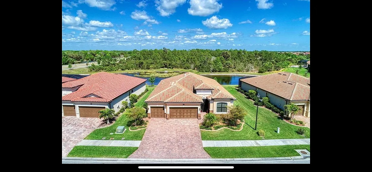 Photo 1 of 33 - 20730 Saluti Pl - Venice, FL Three car air conditioned garage and lush established landscape. - 20730 Saluti Pl