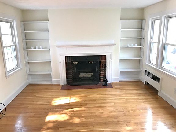 Formal living room features a fire place and built-in book shelves. Sun fills the room both in the morning and in the afternoon!