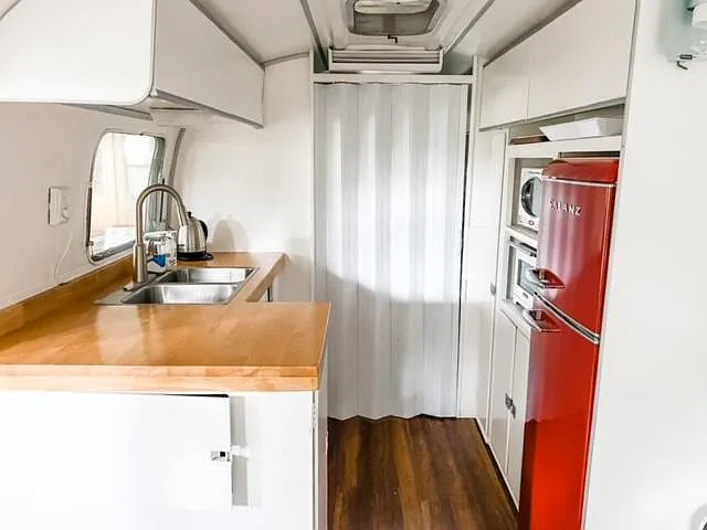 Efficiency kitchen with entrance to the 2 twin-sized beds & Airstream bathroom
