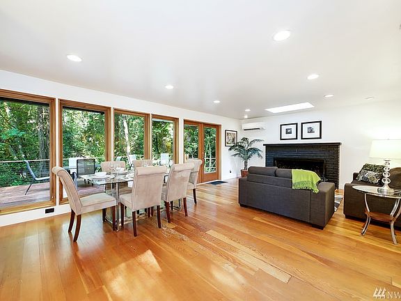 Fir floors and wood wrapped casement windows allow an abundance of natural light into the home year round!  The lushness of the forested view create a sense of peacefulness that's unmatched.  With a 3/4 acre lot that backs to Lakeview Park and Burien Off-Leash Dog Park so there's a ton of privacy.  A seasonal creek at the bottom of the ravine offers lovely and calming nature sounds off the back deck.