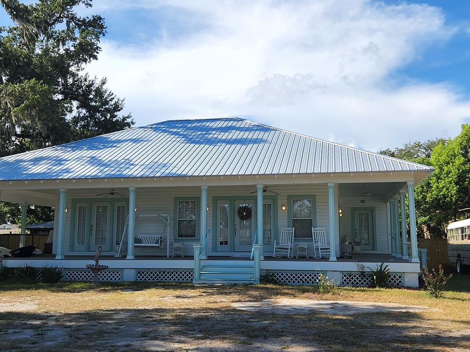 Patsy's cottage from 16th street showing front porch, side porch, front door, and carport