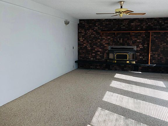 Large living area with hearth. Wood burning stove is currently not useable. West facing for maximum light.