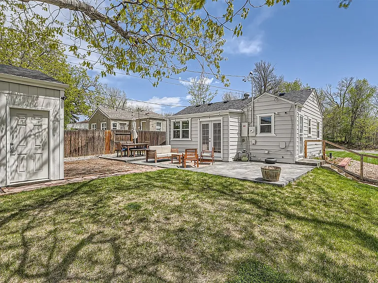Back-yard with detached garage, patio, and french doors