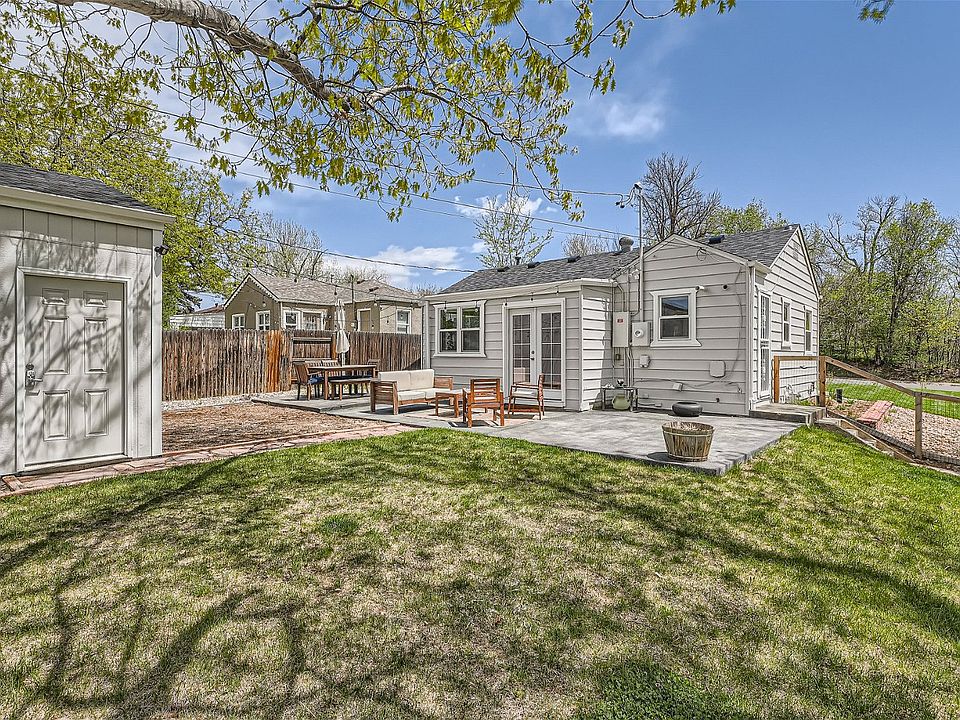 Back-yard with detached garage, patio, and french doors