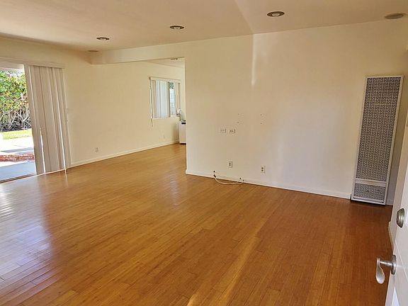 Real Hardwood Floors! Living Room with Bi-fold doors opened.