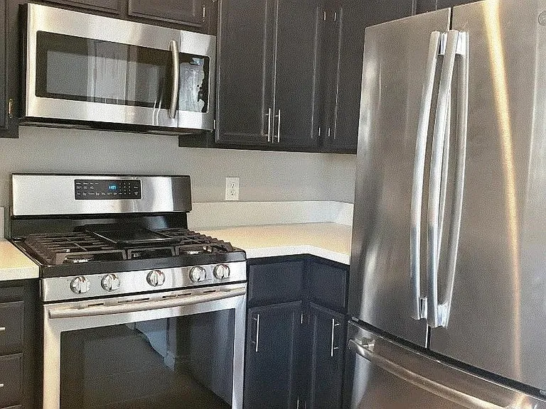 Stainless steel appliances and matching modern cabinet hardware.