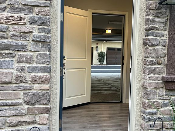 Foyer w/ door open to show garage.