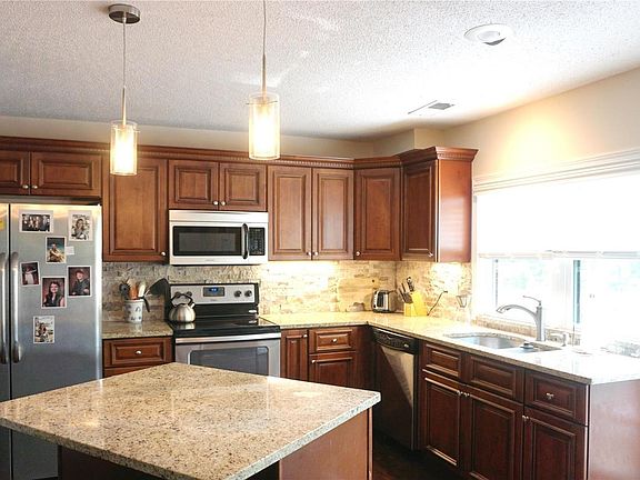 Kitchen is light and bright. Crown molding on the cabinets.
