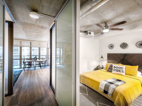 Bedroom with sliding barn door and hard surface flooring