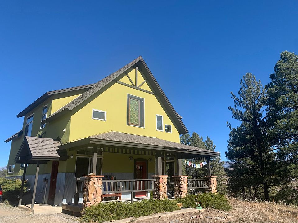 Front of home with front covered porch and covered mudroom entry.