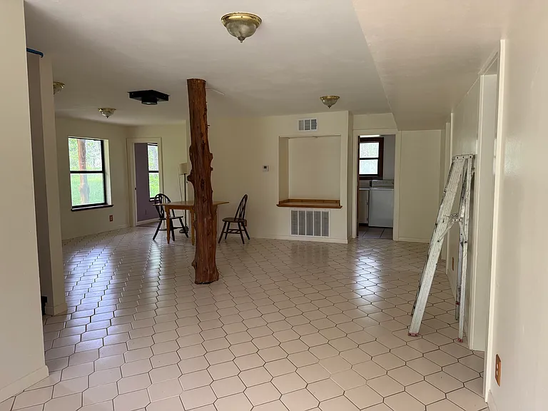View of the dining area and living room from outside the kitchen.