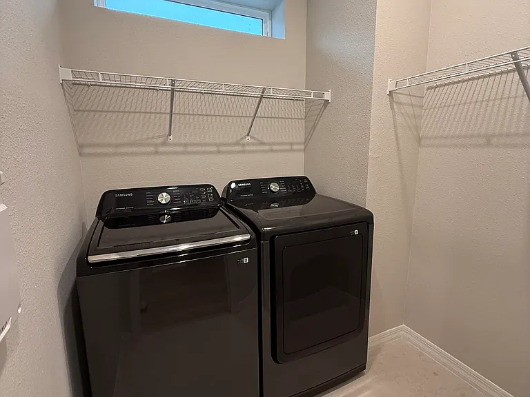 New washer dryer - oversized laundry room with storage, window, pocket door