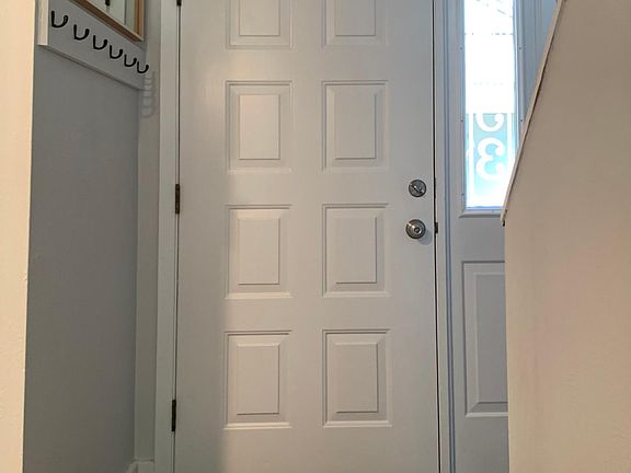 Coat hanging just next to the door.