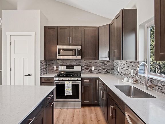 Modern kitchen appliances and cabinets.  Quartz countertops.