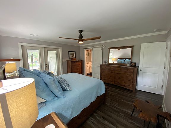 Master suite with french doors to the screened-in porch and a barn door to the master bath.